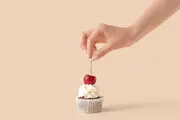 woman-decorating-tasty-cupcake-cherry-600nw-2359907479.webp
